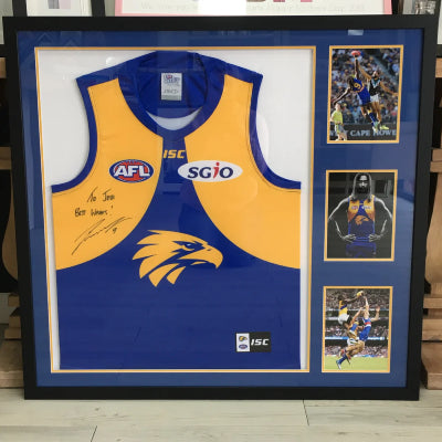 Shadow box frame displaying sports memorabilia including a signed jersey and action photos, professionally framed for display