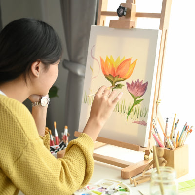 artist painting a watercolour artwork on canvas, delicate brushwork for framed watercolour paintings